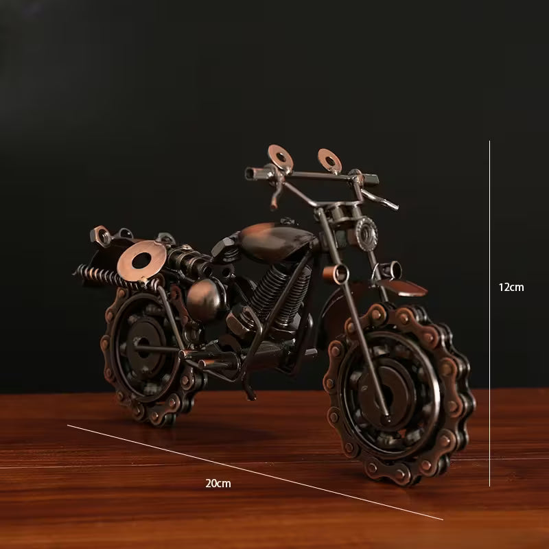Metallic motorcycle model on a wooden surface with measurement indicators.
