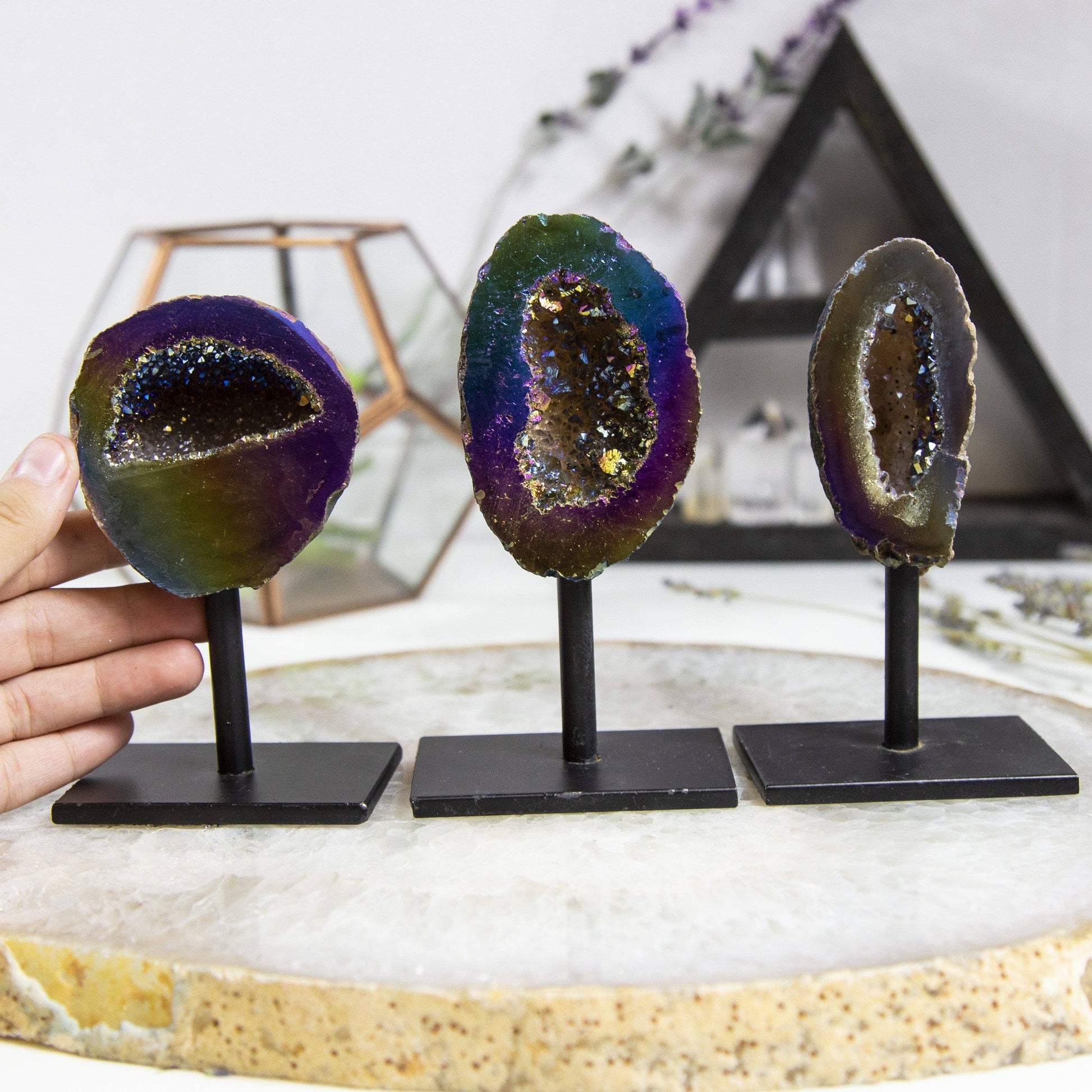 Showcasing a vibrant Rainbow Titanium Aura Geode Crystal on Stand, perfect for promoting positive energy and balance.