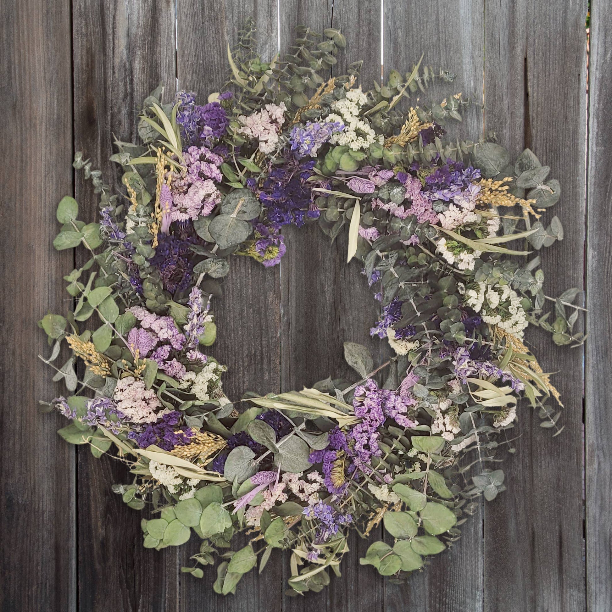 Beautify your home with the Pasadena Wreath, featuring natural eucalyptus and delicate dried flowers.