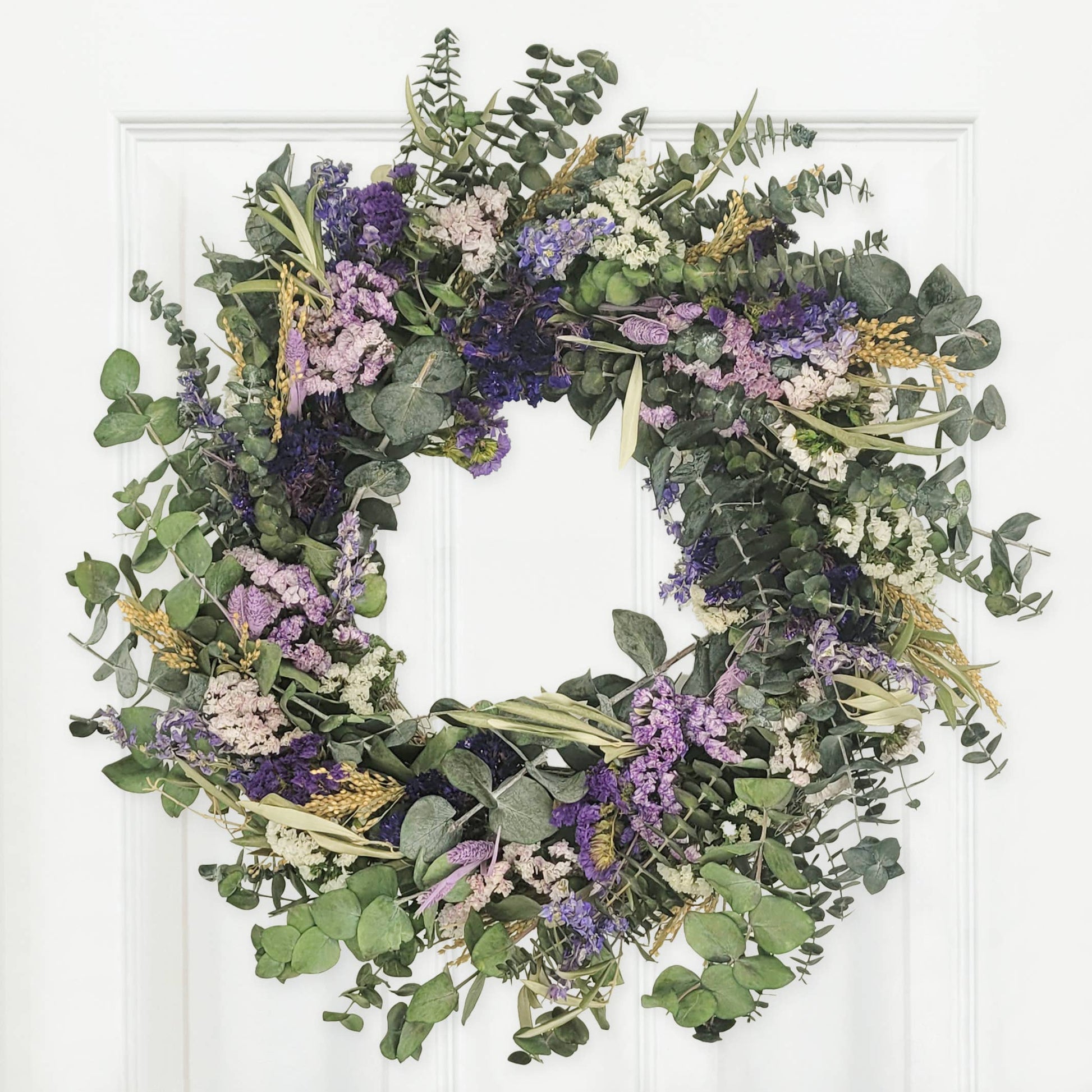 Lively Pasadena Wreath crafted with eucalyptus and dried flowers, adding elegance to any space. Perfectly charming décor.
