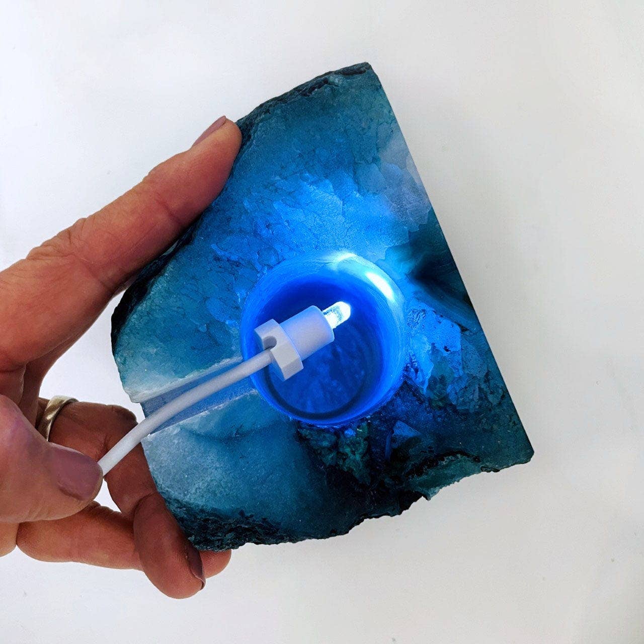 Illuminate your space with the Agate Geode Cut Base Crystal Lamp featuring a vibrant blue dyed agate design.