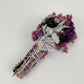 6" Pink smudge wand featuring vibrant flowers, sage, and rose quartz crystal for magical cleansing. Perfect for rituals.