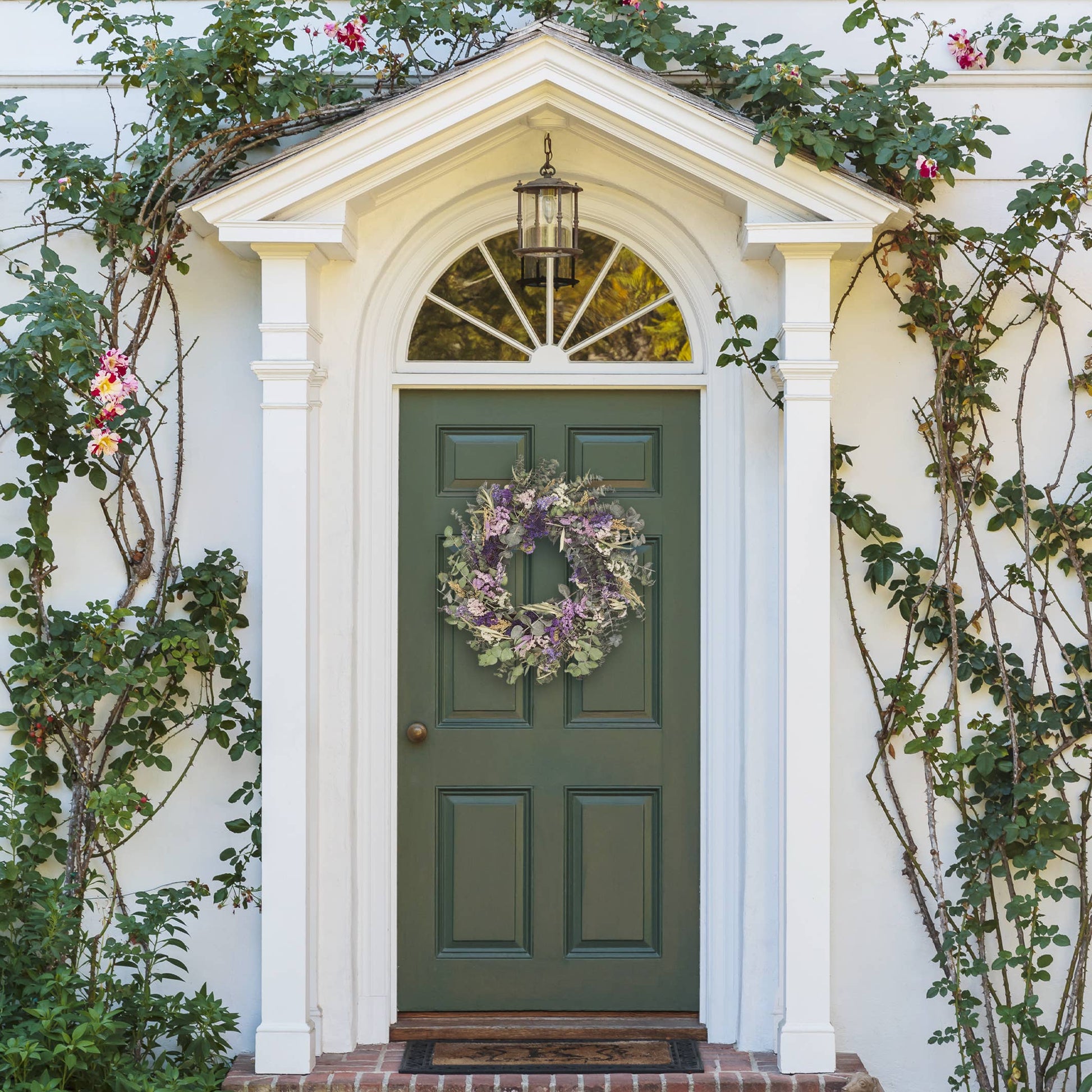 Elegant Pasadena Wreath made of baby eucalyptus and dried flowers, perfect for enhancing any entryway.
