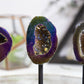 Vibrant Rainbow Titanium Aura Geode Crystal on Stand showcasing stunning hues, perfect for decor and positive energy.