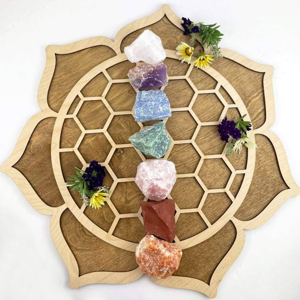 Chakra Rough Stone Crystal Set of 7 - Boxed Collection displayed on a wooden mandala, perfect for energy healing.