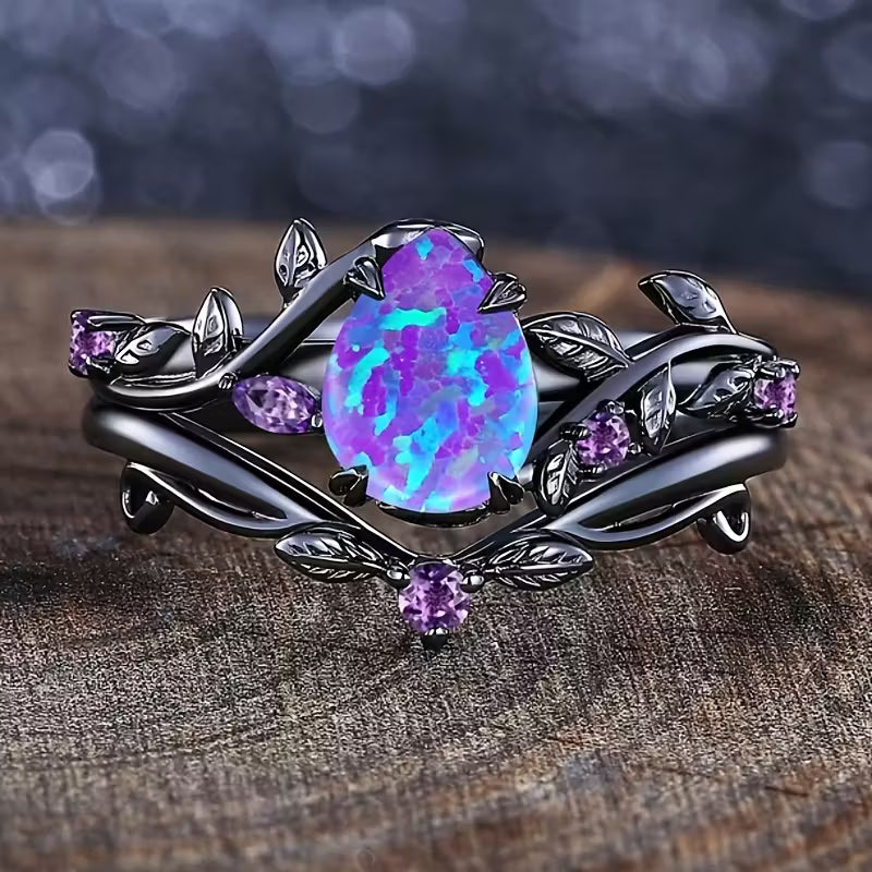 Ornate ring with a purple opal stone on a wooden surface